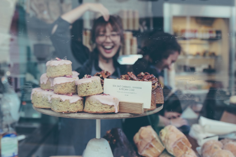 reflection of smiling woman on food display shelf