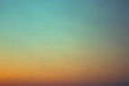 black birds flying under green and orange sky