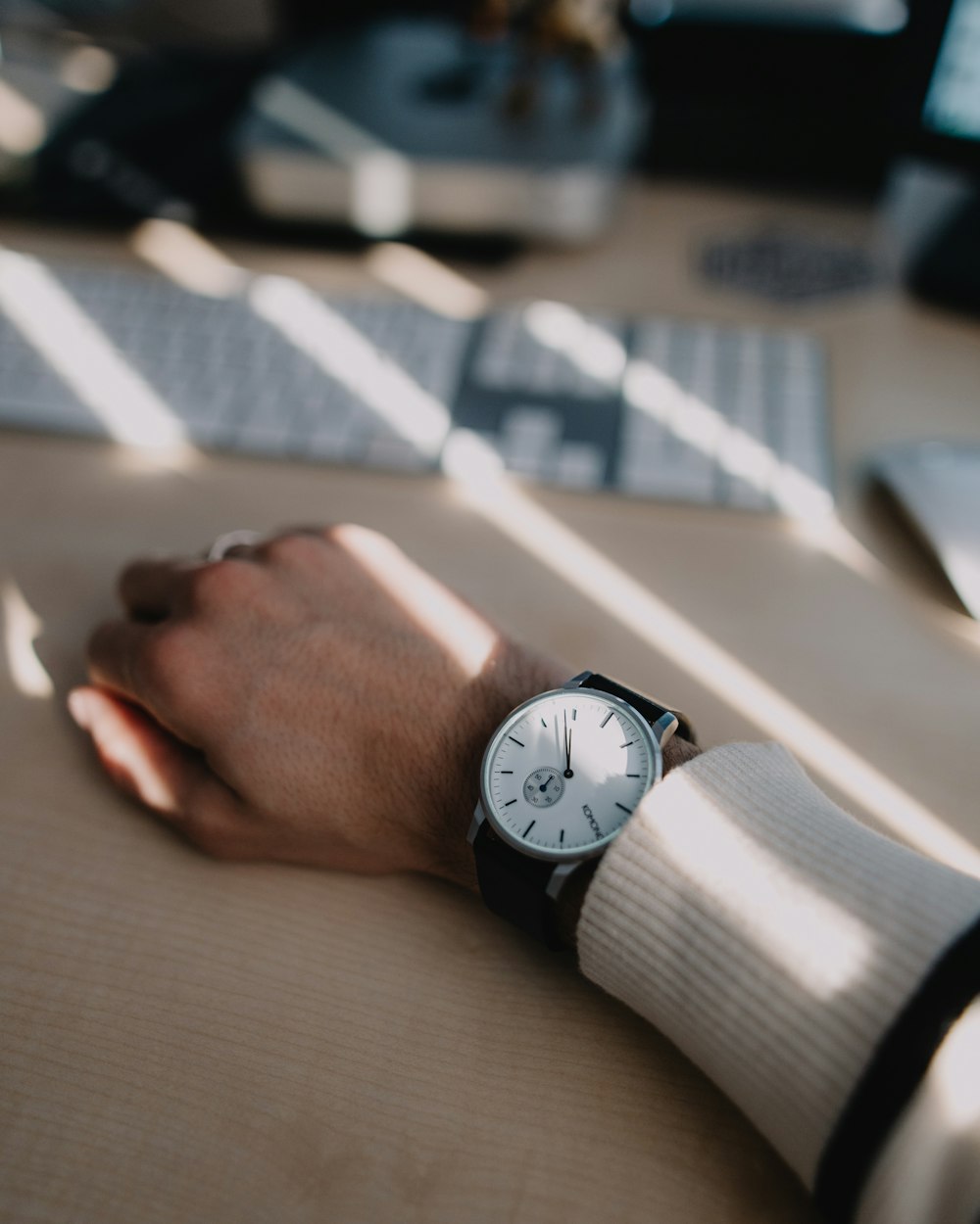 shallow focus photography of men's round white analog watch