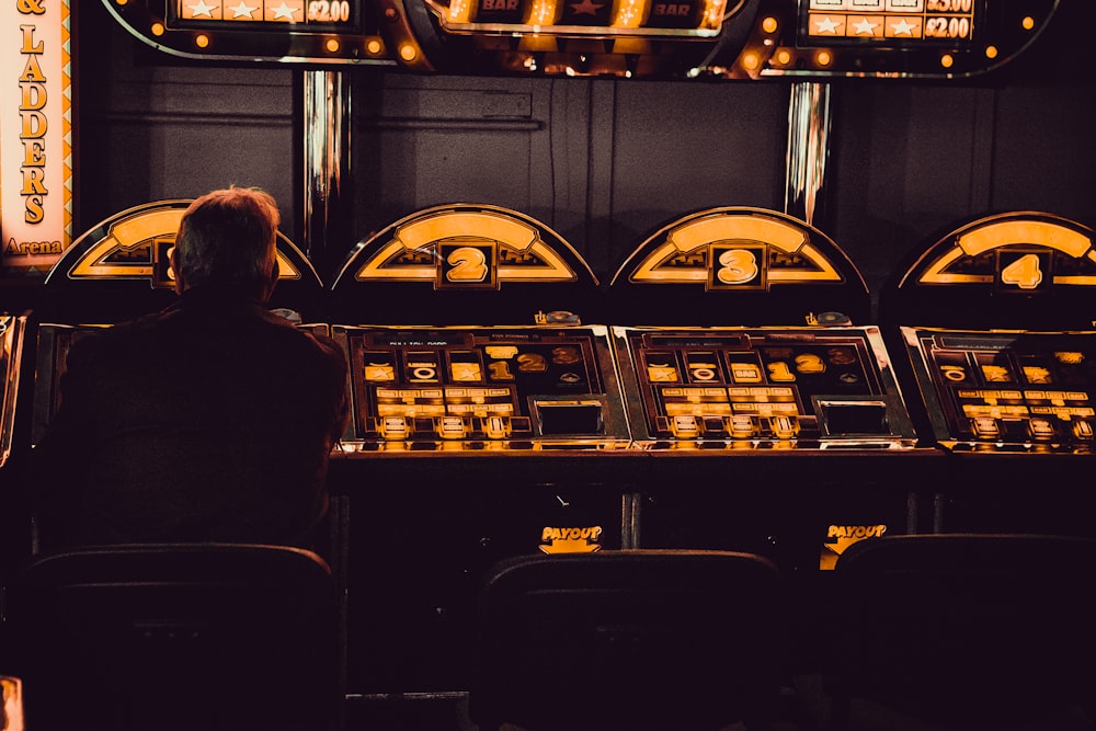 man playing arcade machine