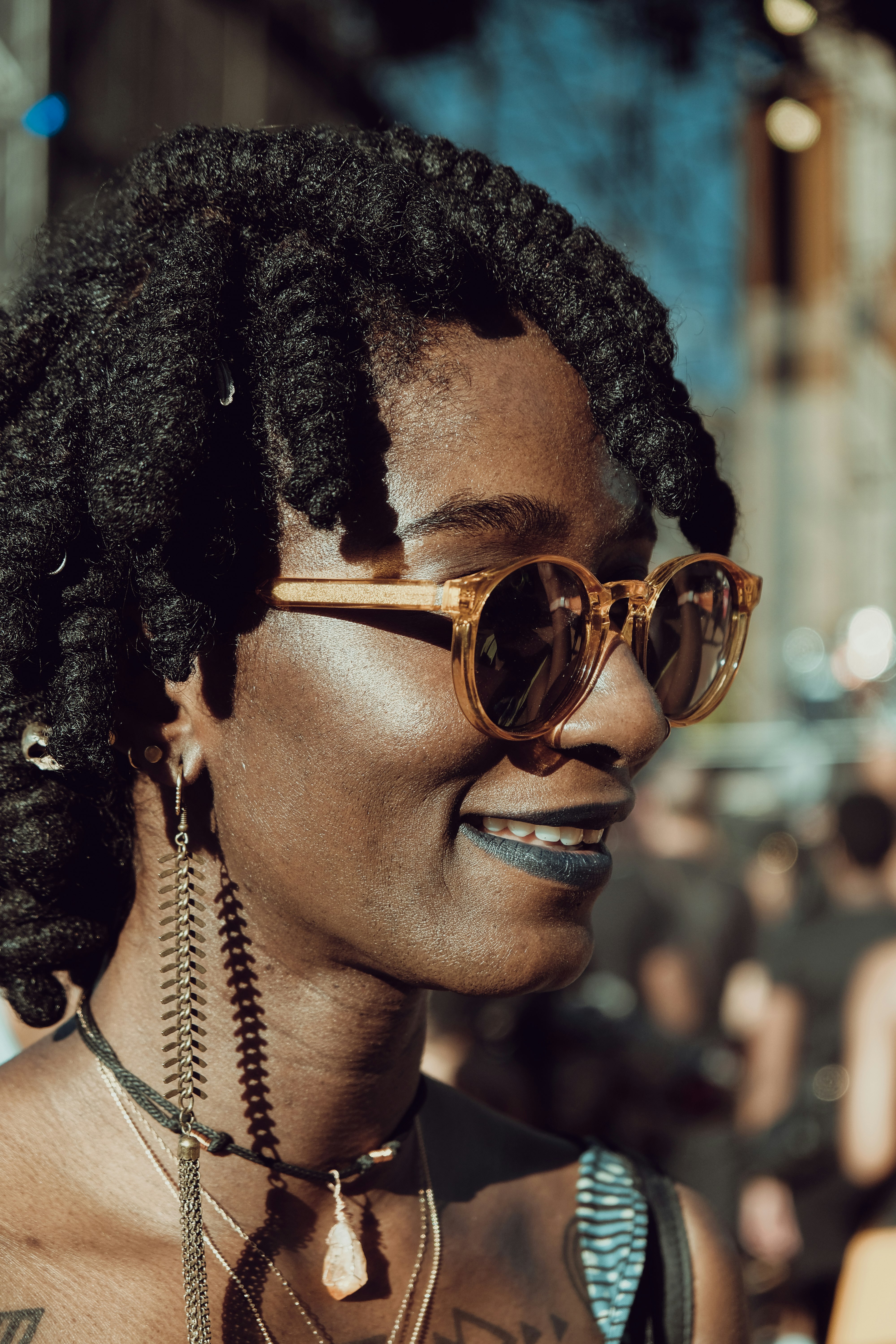 woman with braided hair wearing brown sunglasses