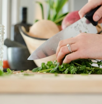 person cutting vegetables with knife