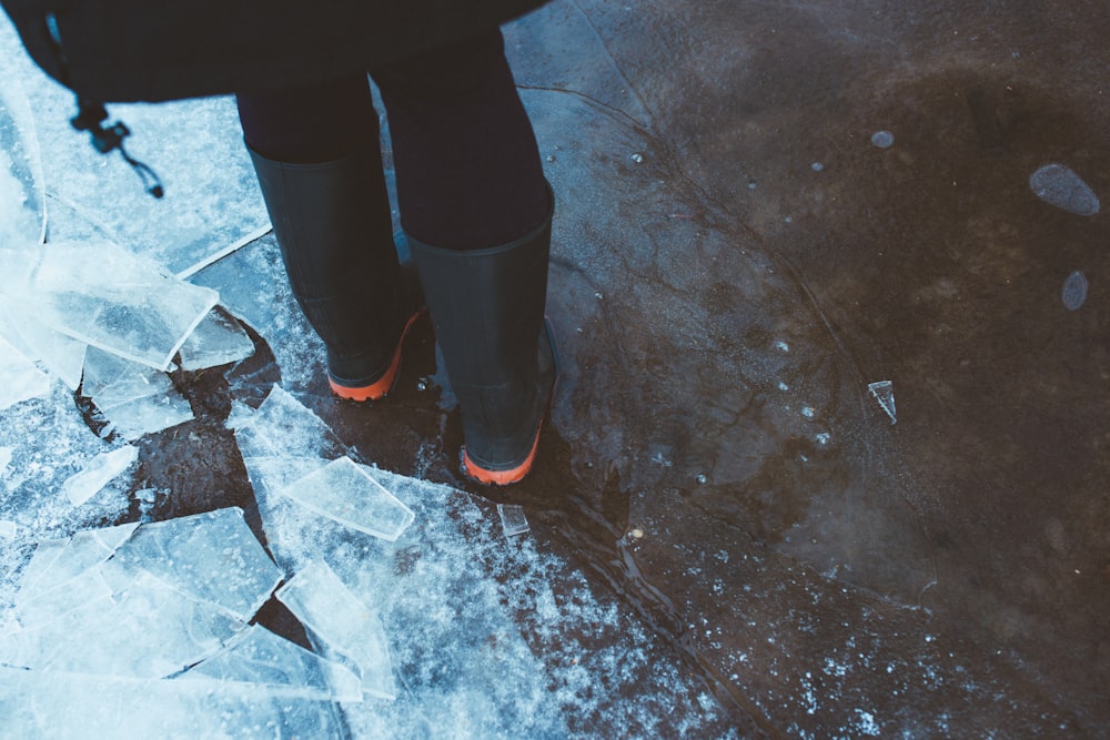 person standing near glass of ice