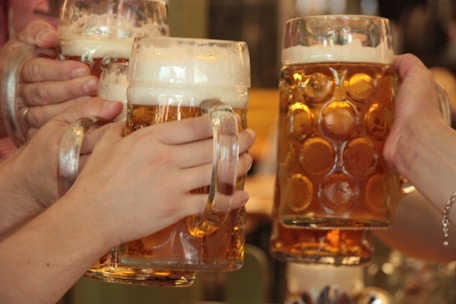 Close-up of frosty beer mugs clinking after a spirited hockey game.