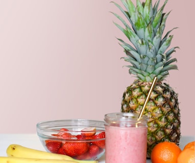 strawberry juice beside fruits on top of table