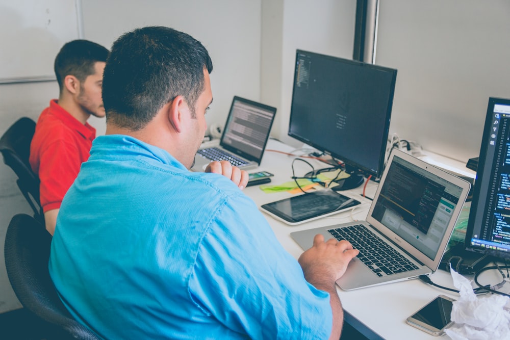 two men using laptop