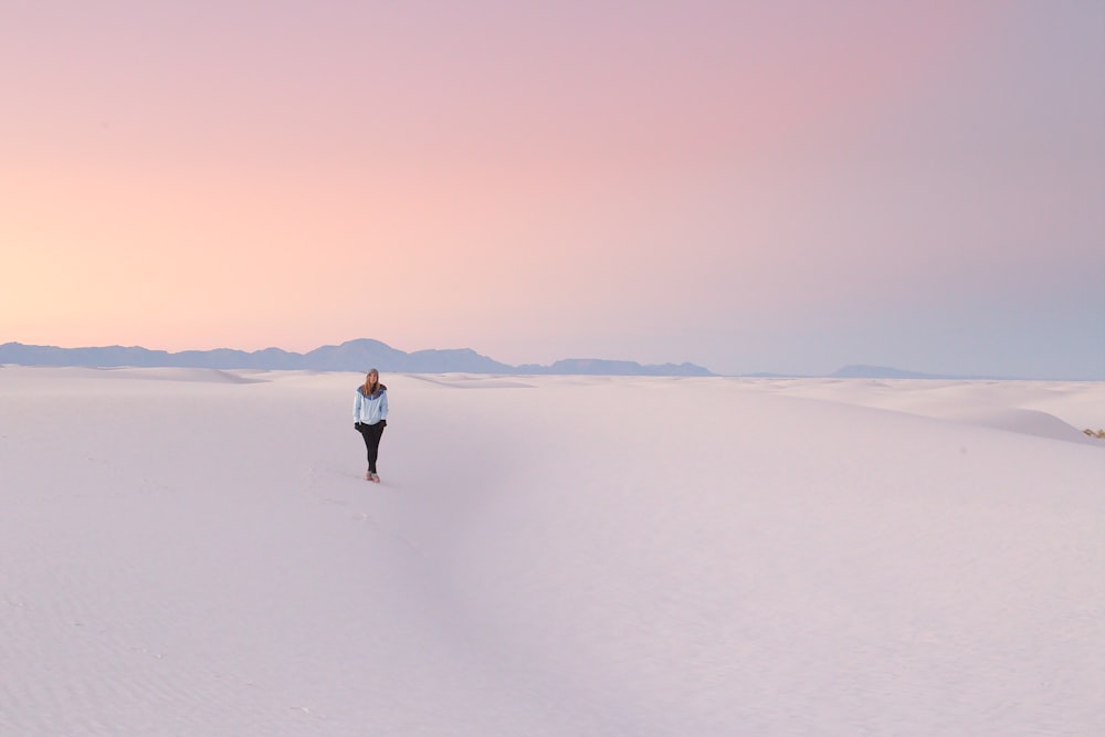 person standing in middle of snow field