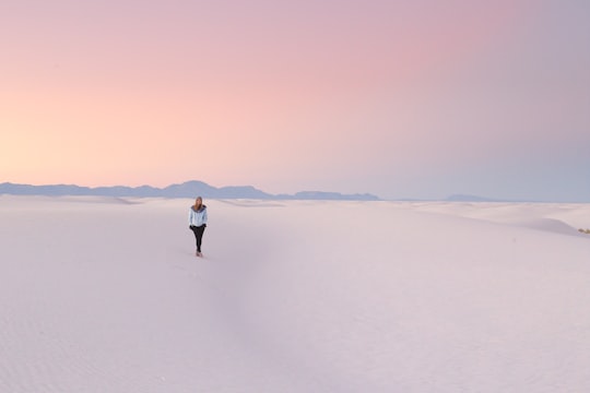 person standing in middle of snow field in White Sands United States
