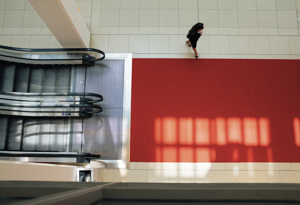 woman walking near elevator inside building