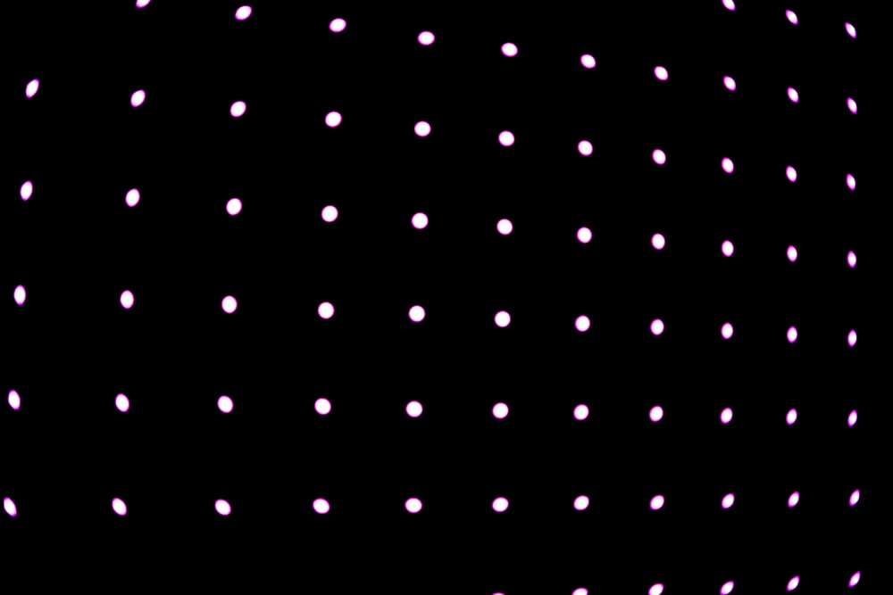 a black background with pink dots on it