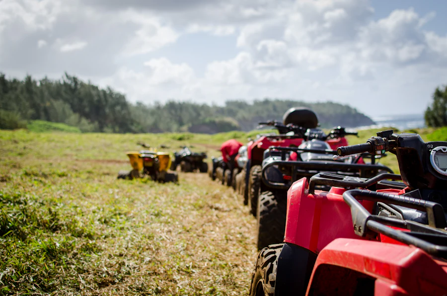A line of quad bikes waiting on a track before a group ride