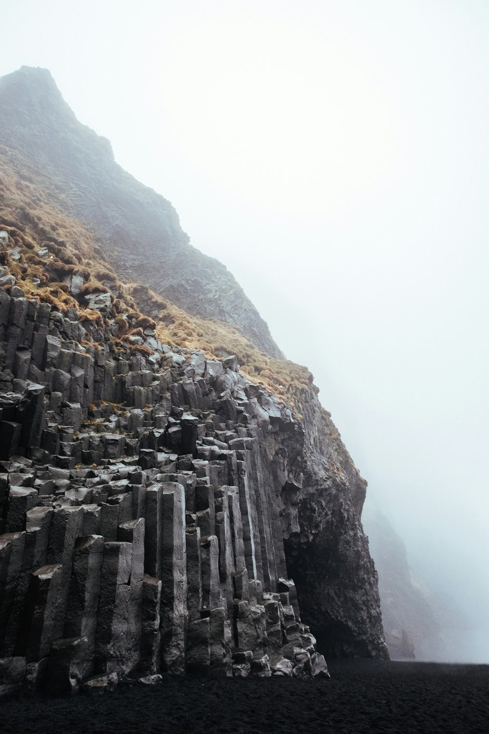 gray cliff under white cloud blue skies