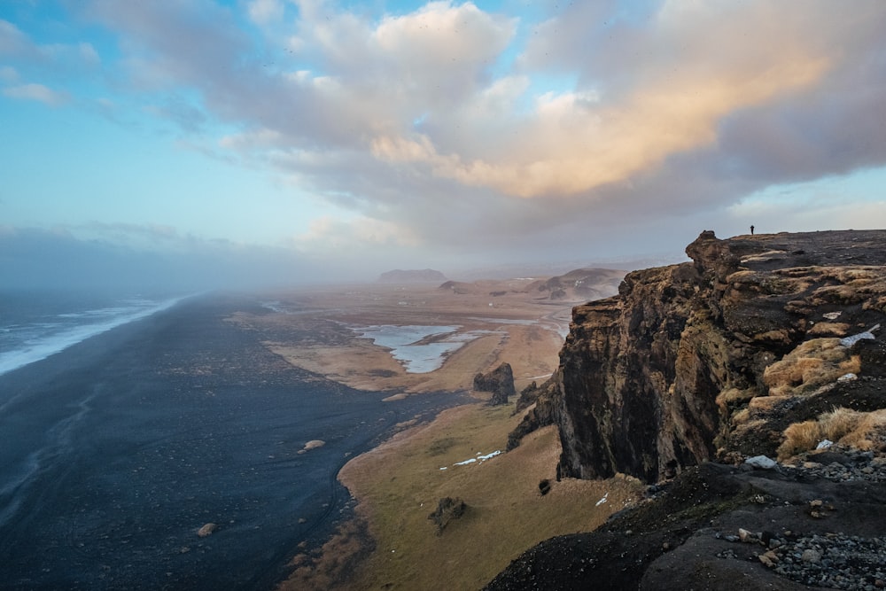 aerial photo of mountain overlooking plain field during daytime