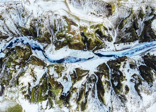 aerial photograph of river and mountain in Fjaðrárgljúfur Canyon Iceland