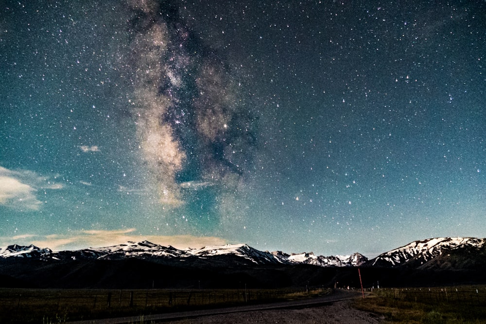 landscape photography of snowy mountains surrounded with grass