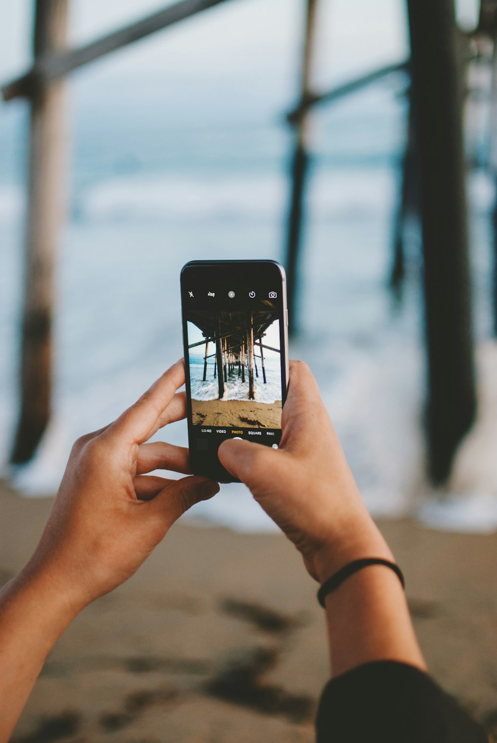 person taking photo using smartphone