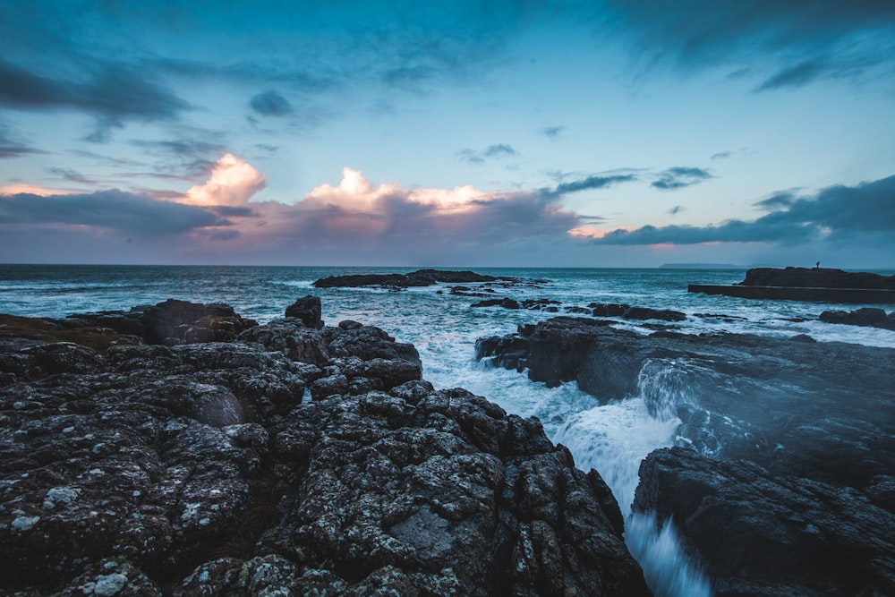 gray rock formation near sea during daytime