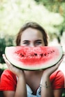 woman holding sliced watermelon