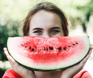 woman holding sliced watermelon