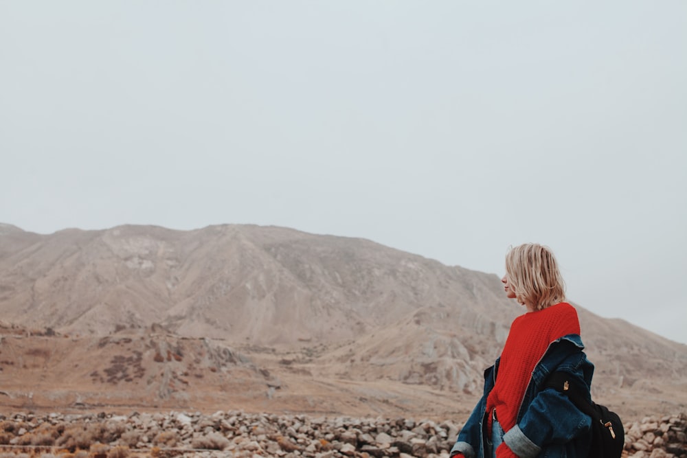 woman standing carrying jacket