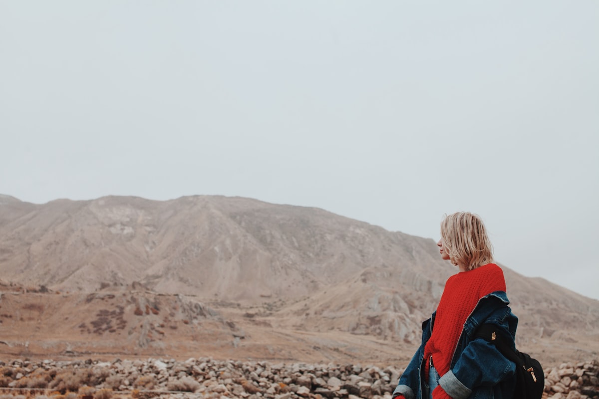 Woman standing carrying jacket