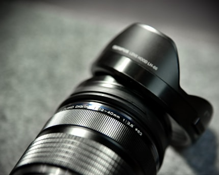 Close-up of a dark olive metal camera accessory crafted by metarc, highlighting its textured finish and precise details.