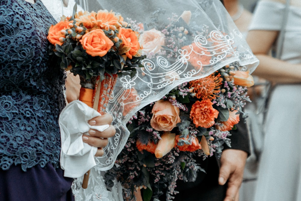 person holding flower bouquet