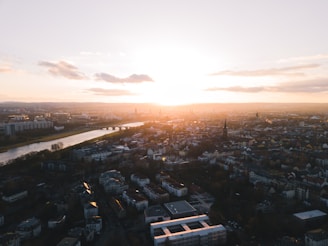 Sunset view over Brisbane River with the city skyline glowing warmly in the background.