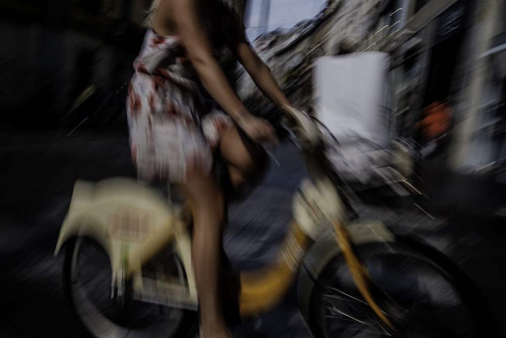 a woman riding a bike down a street