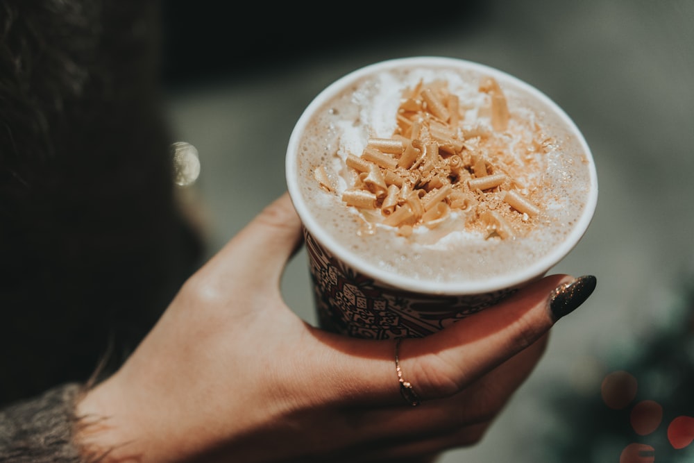 person holding disposable cup