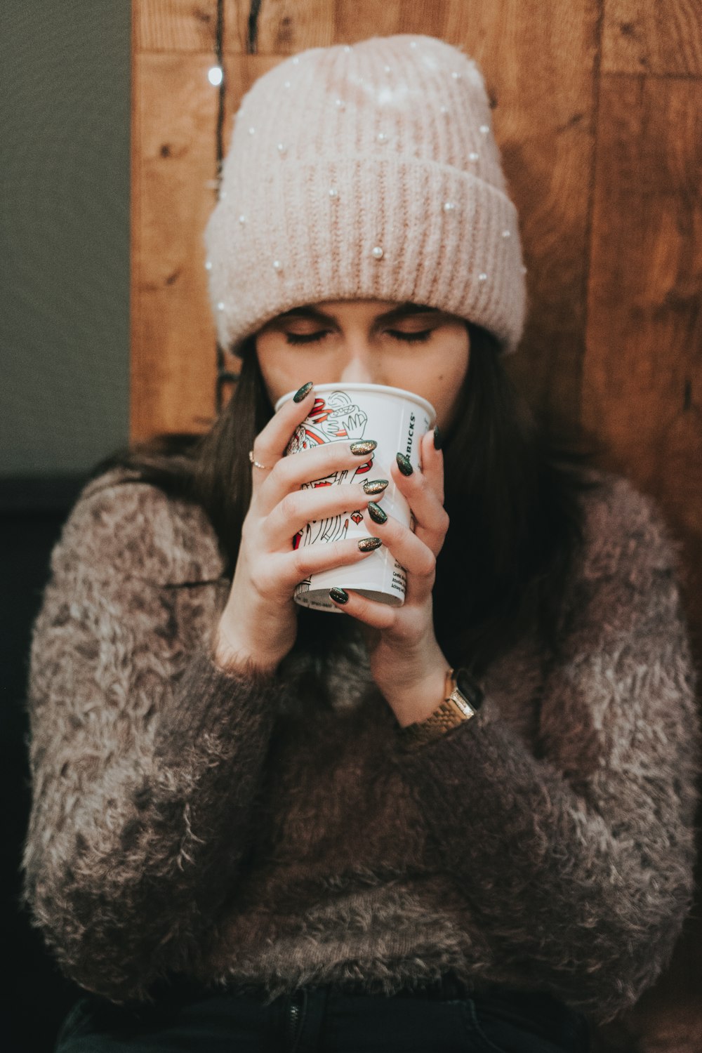 woman holding paper cup