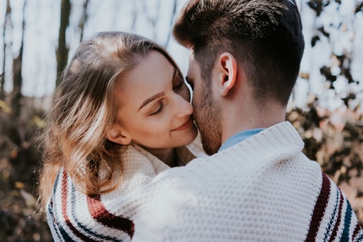 man and woman kissing during daytime