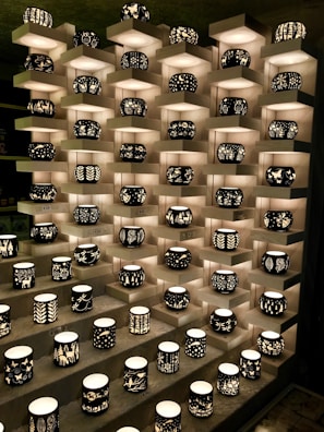 An artistic display of unique candles on a shelf.