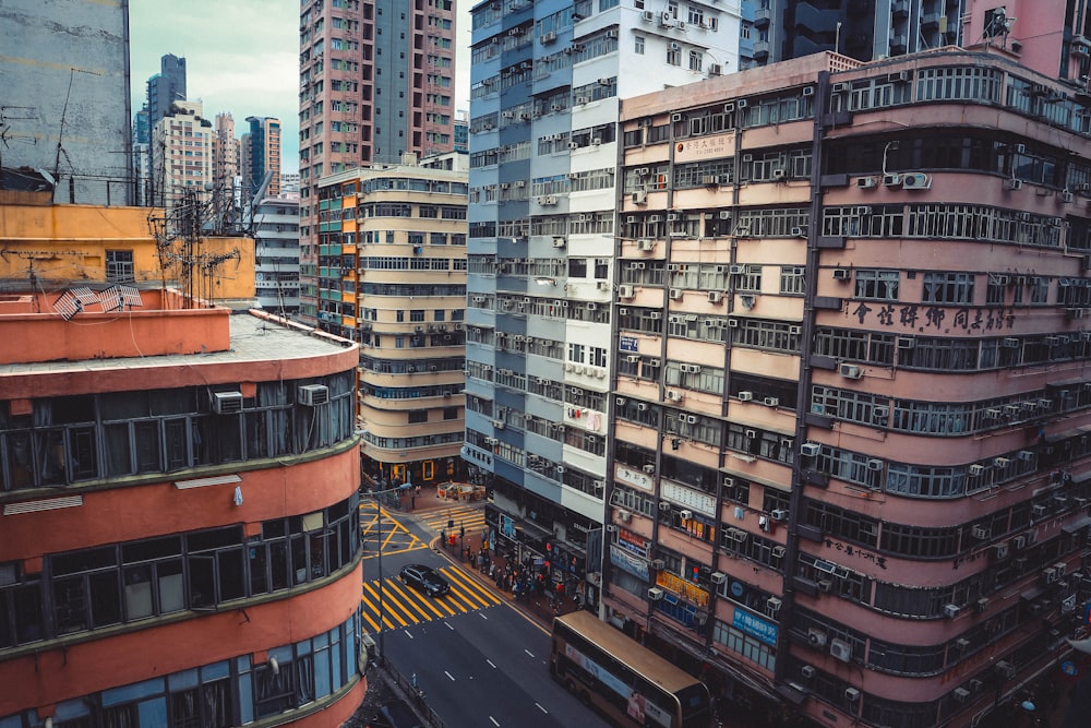 people crossing street near brown concrete buildings