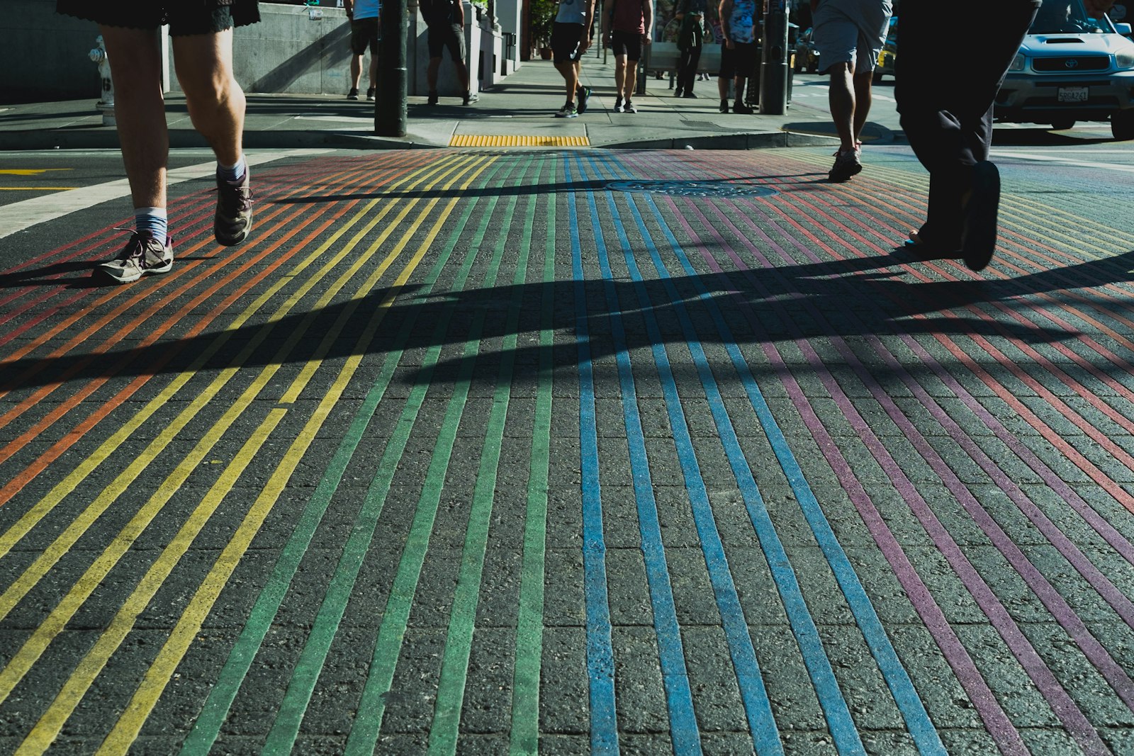 Fujifilm X-E1 + Fujifilm XF 27mm F2.8 sample photo. People walking on multicolored photography