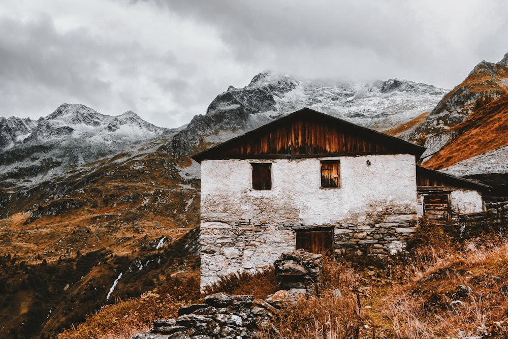 photo of brown house near mountains