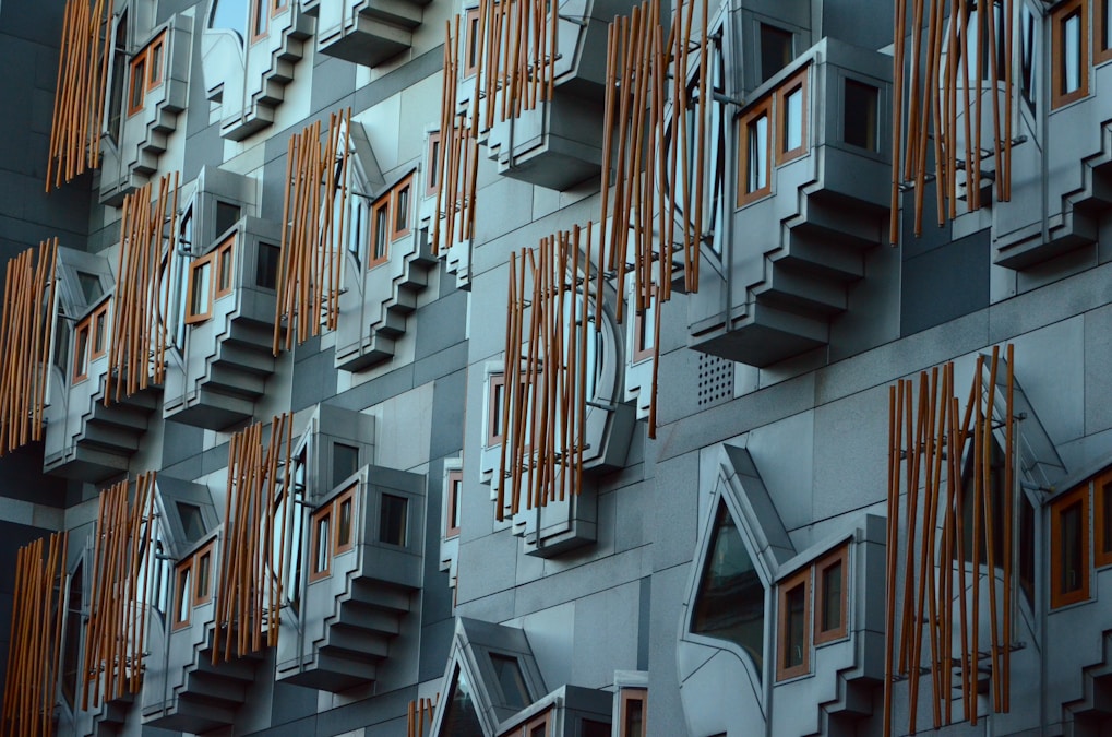 Exterior of the Scottish Parliament Building. Taken at around 2pm on New Year’s Day 2013. A city full of historic architecture and that has UNESCO World heritage status that contrasts with this post modern example of architecture by Enric Miralles who died before the building was completed in around 2004.The jutting shapes are ‘think pods’ for Members of the Scottish Parliament (MSPs) to spend time in to reflect.