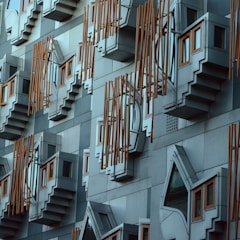 Exterior of the Scottish Parliament Building. Taken at around 2pm on New Year’s Day 2013. A city full of historic architecture and that has UNESCO World heritage status that contrasts with this post modern example of architecture by Enric Miralles who died before the building was completed in around 2004.The jutting shapes are ‘think pods’ for Members of the Scottish Parliament (MSPs) to spend time in to reflect.