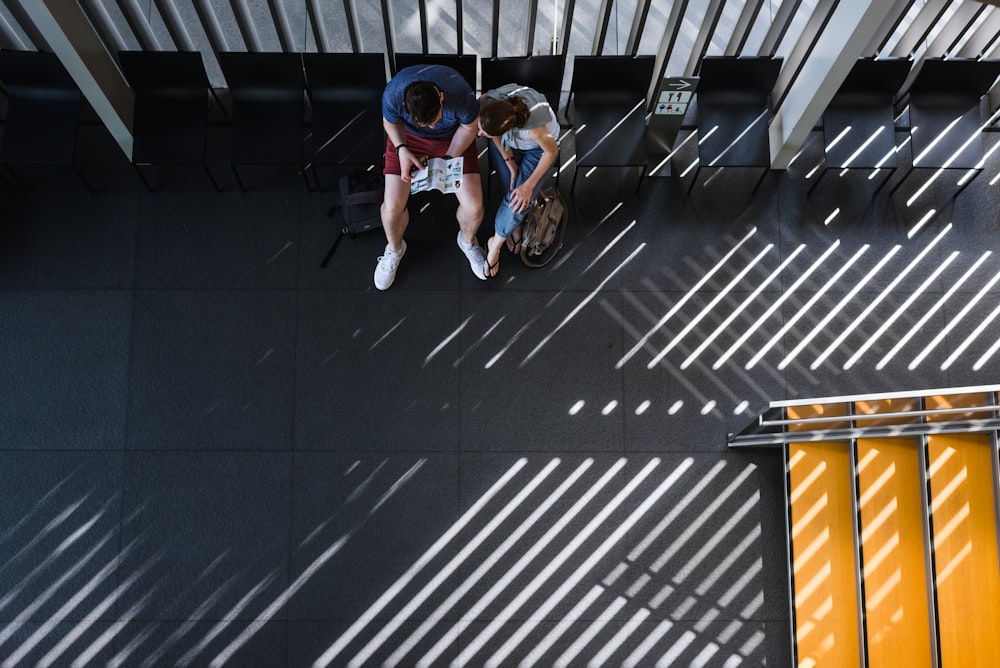 man and woman sitting on chairs