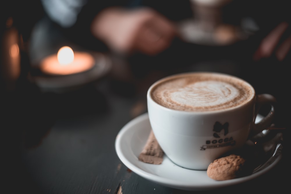 white ceramic mug with cappuccino