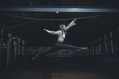 woman jumping inside room dancer zoom background