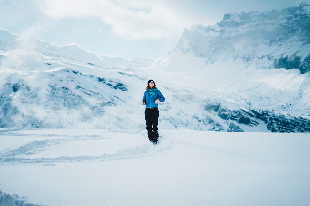 person standing on snow mountain