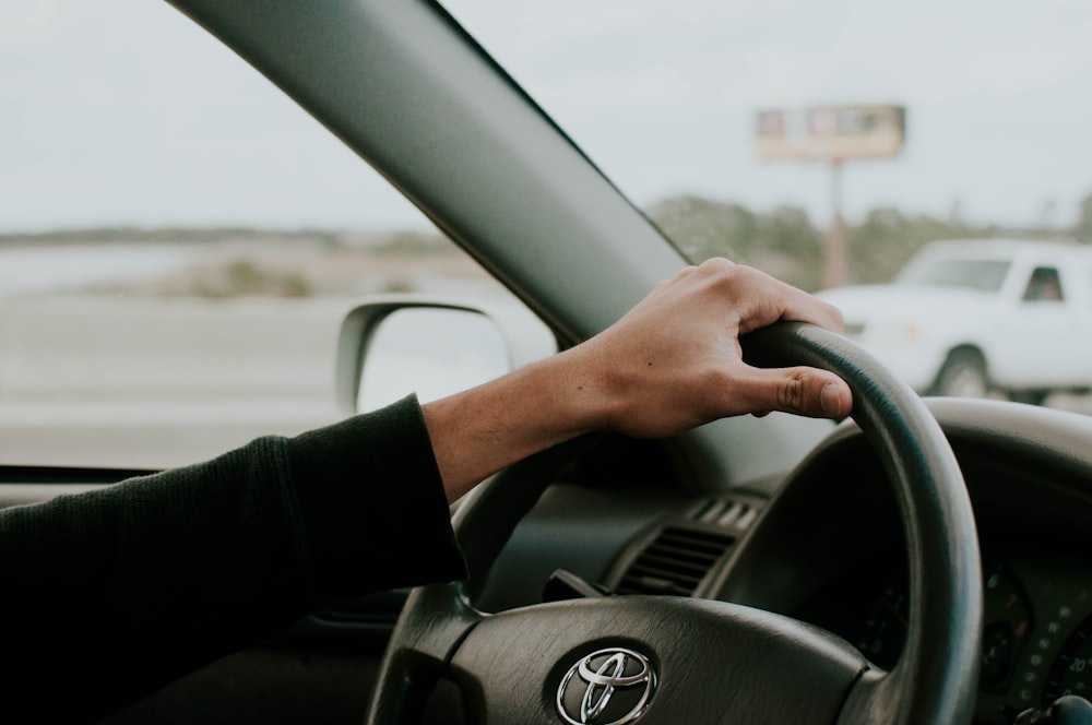 person driving Toyota car