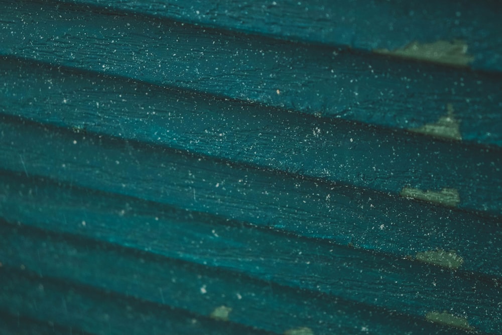 a close up of a green building with snow on it