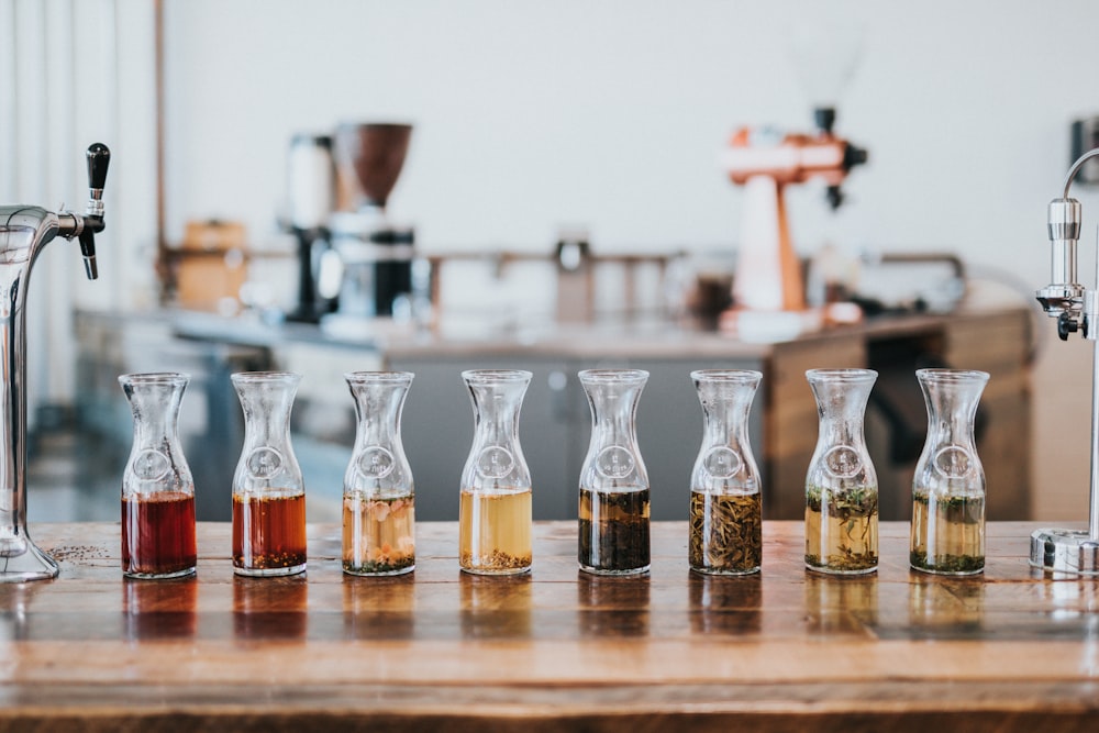 assorted glass with liquid labeled on top of table inside the room