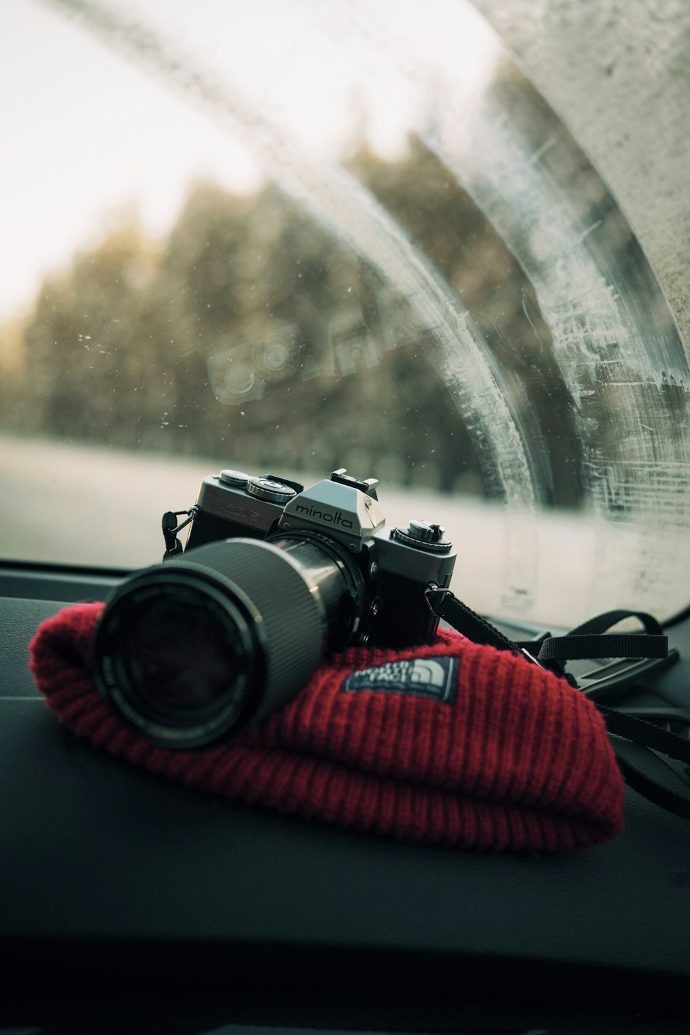 photo of gray Minolta DSLR camera on glove compartment