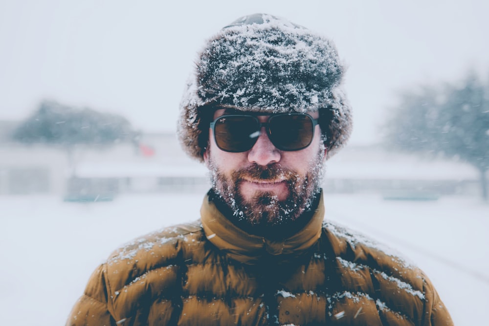 man wearing brown bubble jacket with black hat