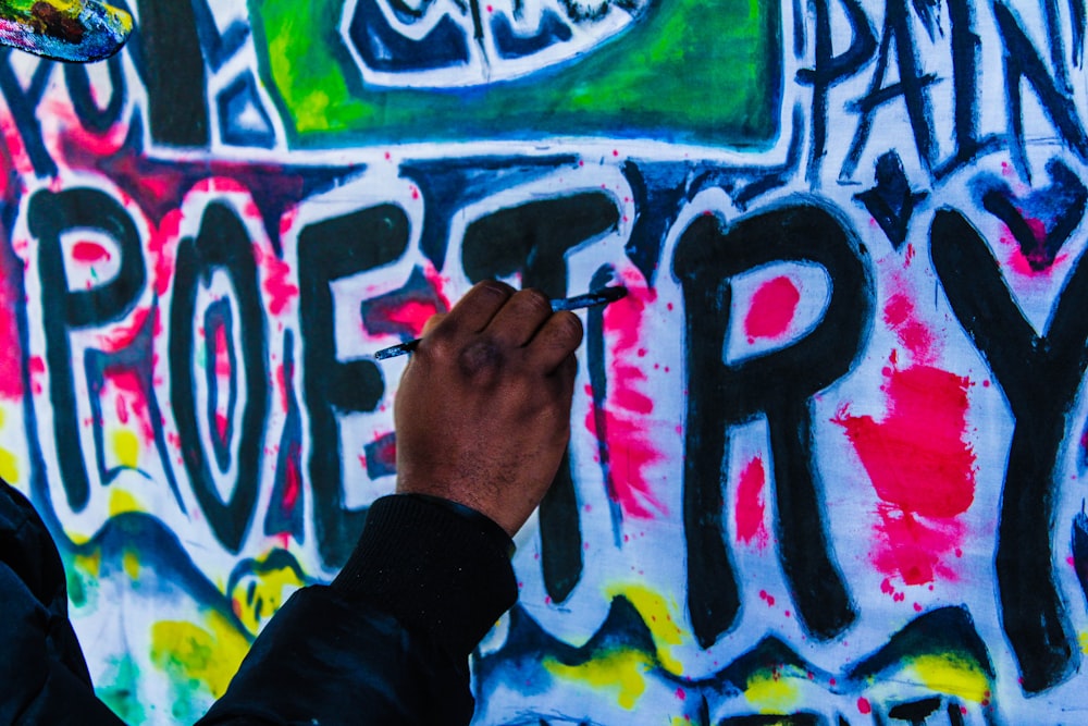 person doing wall graffiti