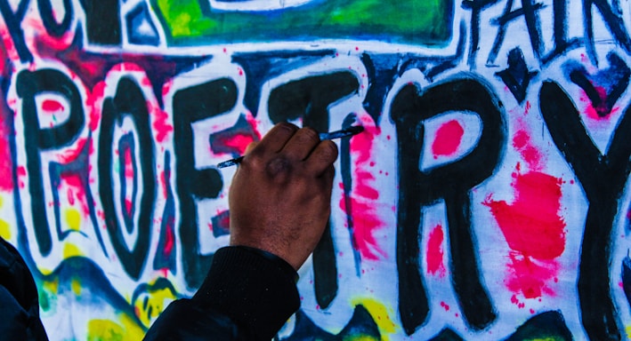 person doing wall graffiti