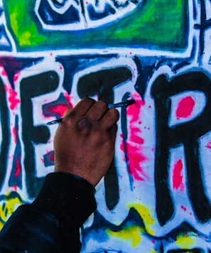 person doing wall graffiti